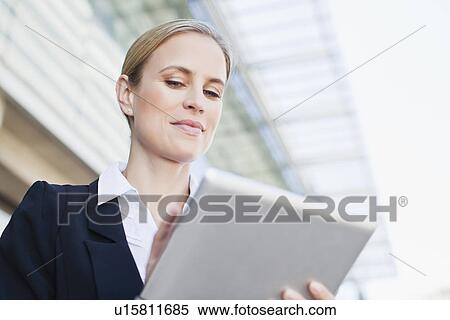 Businesswoman using tablet computer View Large Photo Image Stock Photography - Businesswoman using tablet computer. Fotosearch