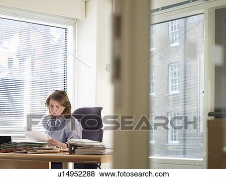 Businesswoman working at desk View Large Photo Image Stock Photo - Businesswoman working at desk. Fotosearch