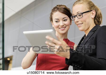 Picture - Businesswomen using tablet computer. Fotosearch