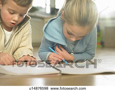 Stock Photo - Children drawing together on floor. Fotosearch