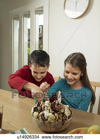 Children eating large bowl of ice cream View Large Photo Image Picture - Children eating large bowl of ice cream. Fotosearch