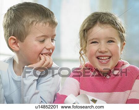 Children laughing together indoors View Large Photo Image Stock Image - Children laughing together indoors. Fotosearch