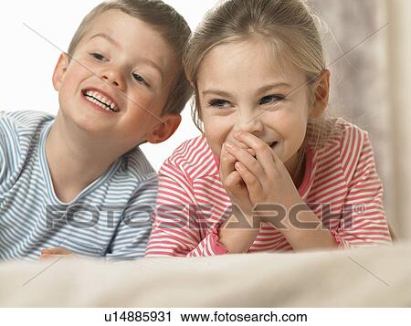 Children laughing together on bed View Large Photo Image Stock Image - Children laughing together on bed. Fotosearch