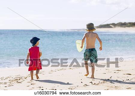 Picture - Children playing in sand on beach. Fotosearch