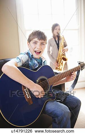 Stock Photograph - Children playing music together. Fotosearch