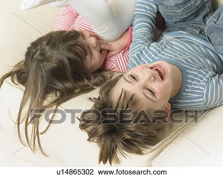 Children playing on sofa together View Large Photo Image Stock Image - Children playing on sofa together. Fotosearch