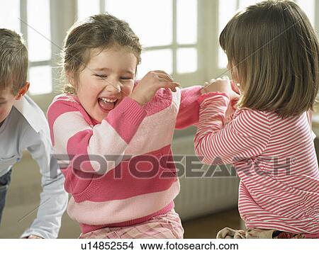 Picture - Children playing together indoors. Fotosearch