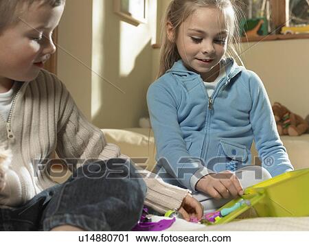Stock Image - Children playing together indoors. Fotosearch