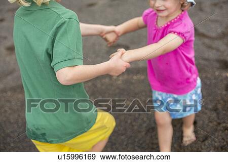 Children playing together on beach View Large Photo Image Stock Photo - Children playing together on beach. Fotosearch