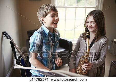 Children playing with saxophone View Large Photo Image Stock Image - Children playing with saxophone. Fotosearch