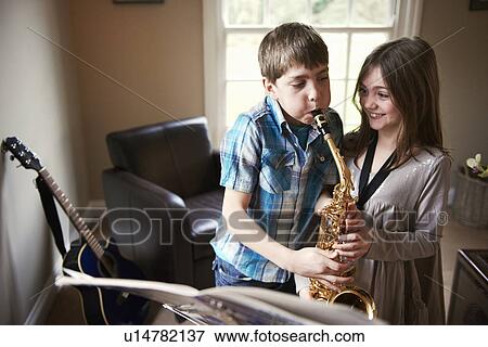 Children playing with saxophone View Large Photo Image Stock Photo - Children playing with saxophone. Fotosearch