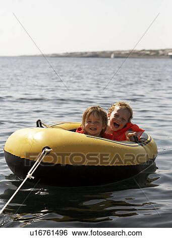 Children riding in inflatable boat View Large Photo Image Stock Photograph - Children riding in inflatable boat. Fotosearch