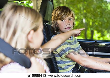 Stock Image - Children sitting in backseat of car. Fotosearch
