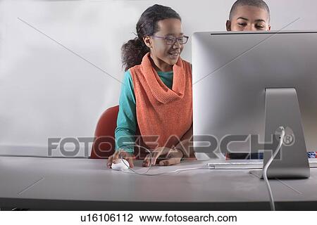 Stock Image - Children using computer together. Fotosearch