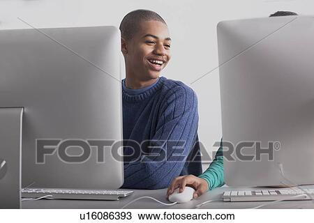 Stock Image - Children using computers at desk. Fotosearch