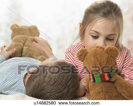 Stock Image - Children with teddy bears indoors. Fotosearch