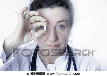 Close up of doctor holding pill View Large Photo Image Stock Photograph - Close up of doctor holding pill. Fotosearch