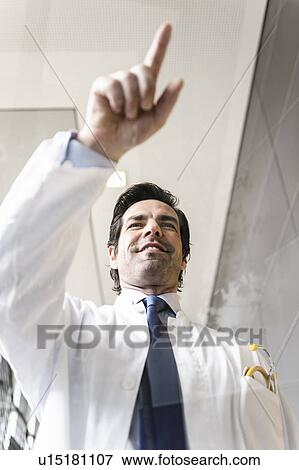 Close up of doctor touching glass panel View Large Photo Image Stock Photo - Close up of doctor touching glass panel. Fotosearch