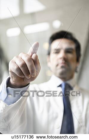 Stock Photograph - Close up of doctor touching glass panel. Fotosearch