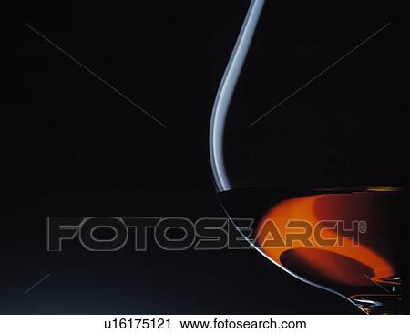 Stock Image - Close up of glass of brandy. Fotosearch