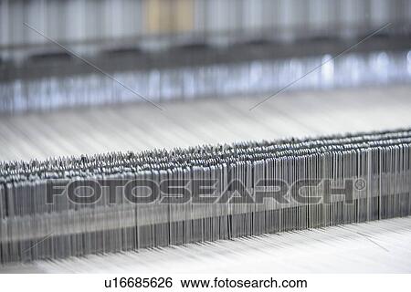 Stock Photograph - Close up of loom in textile mill. Fotosearch