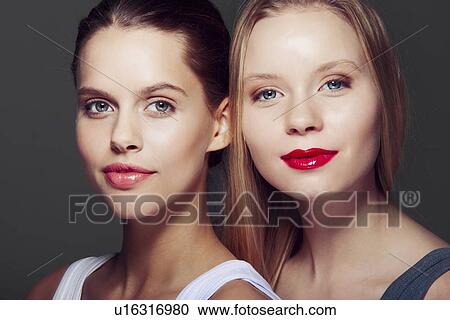 Stock Image - Close up of smiling womens faces. Fotosearch