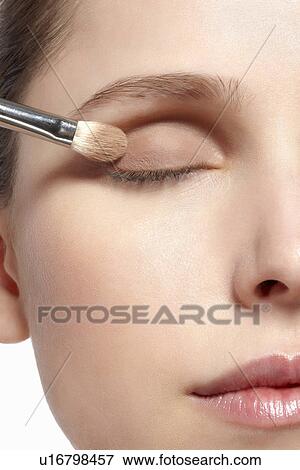 Stock Photo - Close up of woman applying makeup. Fotosearch