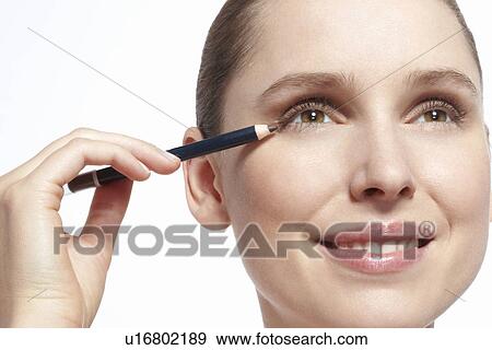 Close up of woman applying makeup View Large Photo Image Stock Photo - Close up of woman applying makeup. Fotosearch