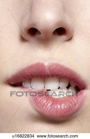 Close up of woman biting her lip View Large Photo Image Picture - Close up of woman biting her lip. Fotosearch