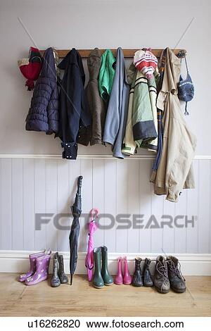 Coats on coat rack with boots View Large Photo Image Stock Image - Coats on coat rack with boots. Fotosearch