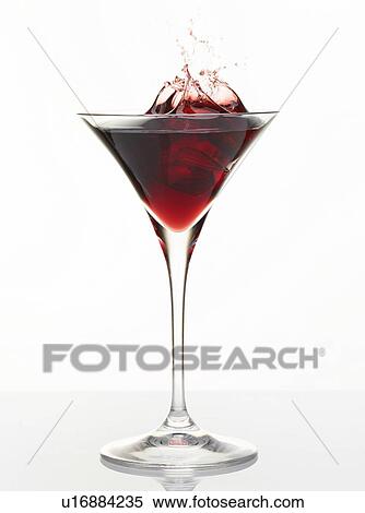 Cocktail splashing in glass View Large Photo Image Stock Photography - Cocktail splashing in glass. Fotosearch