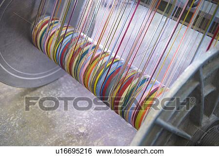 Colorful yarn on loom in textile mill View Large Photo Image Stock Photograph - Colorful yarn on loom in textile mill. Fotosearch