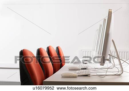 Computers and chairs at desk View Large Photo Image Stock Image - Computers and chairs at desk. Fotosearch