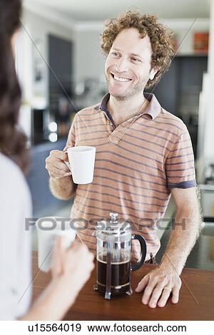 Stock Photo - Couple drinking coffee together. Fotosearch