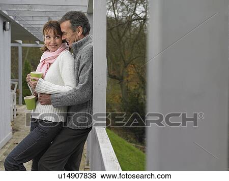 Stock Photo - Couple having coffee together on patio. Fotosearch