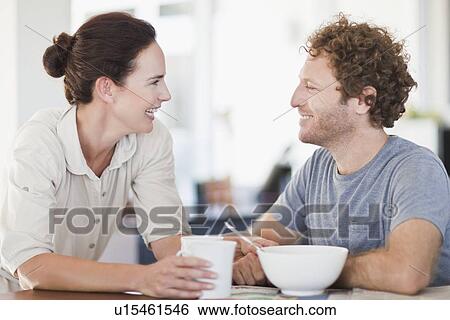 Stock Photograph - Couple talking at breakfast. Fotosearch