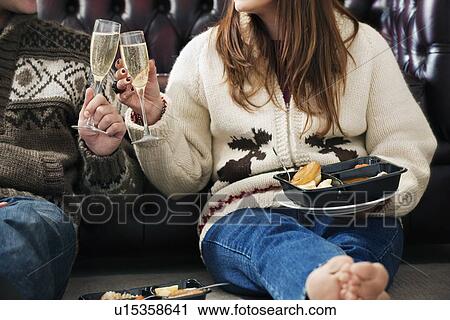 Stock Image - Couple toasting each other. Fotosearch