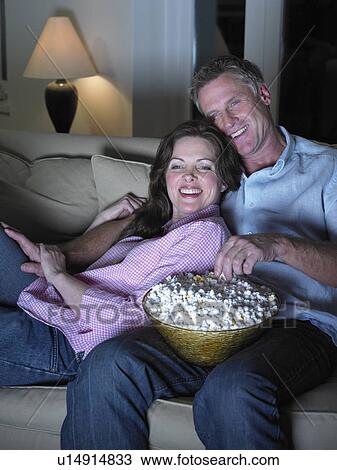 Stock Image - Couple watching movie together. Fotosearch