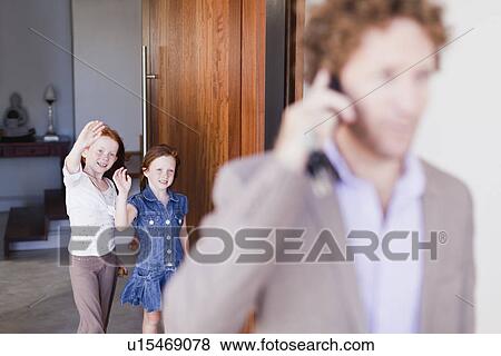 Stock Photo - Daughters waving goodbye to father. Fotosearch