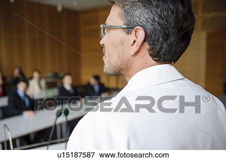 Stock Photo - Doctor addressing audience in room. Fotosearch