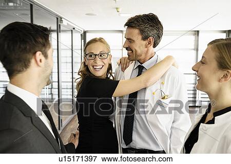 Doctor and businesswoman hugging View Large Photo Image Stock Photo - Doctor and businesswoman hugging. Fotosearch