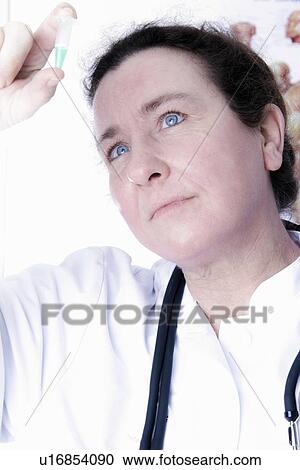 Doctor examining pill View Large Photo Image Stock Image - Doctor examining pill. Fotosearch