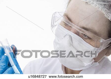 Doctor in face mask using tablet computer View Large Photo Image Stock Photo - Doctor in face mask using tablet computer. Fotosearch