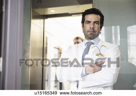 Stock Photo - Doctor standing in hallway. Fotosearch