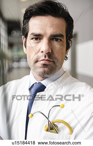 Doctor standing in hallway View Large Photo Image Stock Photo - Doctor standing in hallway. Fotosearch