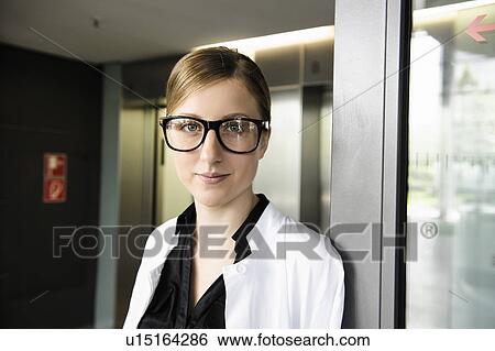 Stock Photograph - Doctor standing in hallway. Fotosearch