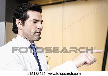 Doctor touching glass panel View Large Photo Image Picture - Doctor touching glass panel. Fotosearch