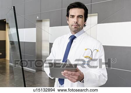 Picture - Doctor using tablet computer. Fotosearch