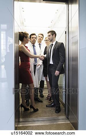 Doctors and business people in elevator View Large Photo Image Stock Image - Doctors and business people in elevator. Fotosearch