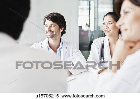 Stock Photography - Doctors smiling in meeting. Fotosearch